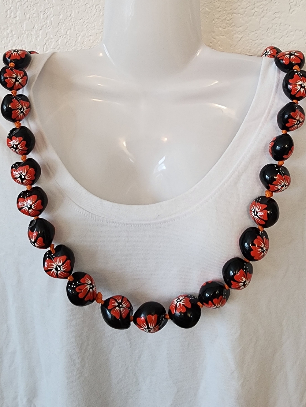 Hawaiian Kukui Nut Lei With Hand-Painted Black, Red Floral Accents.